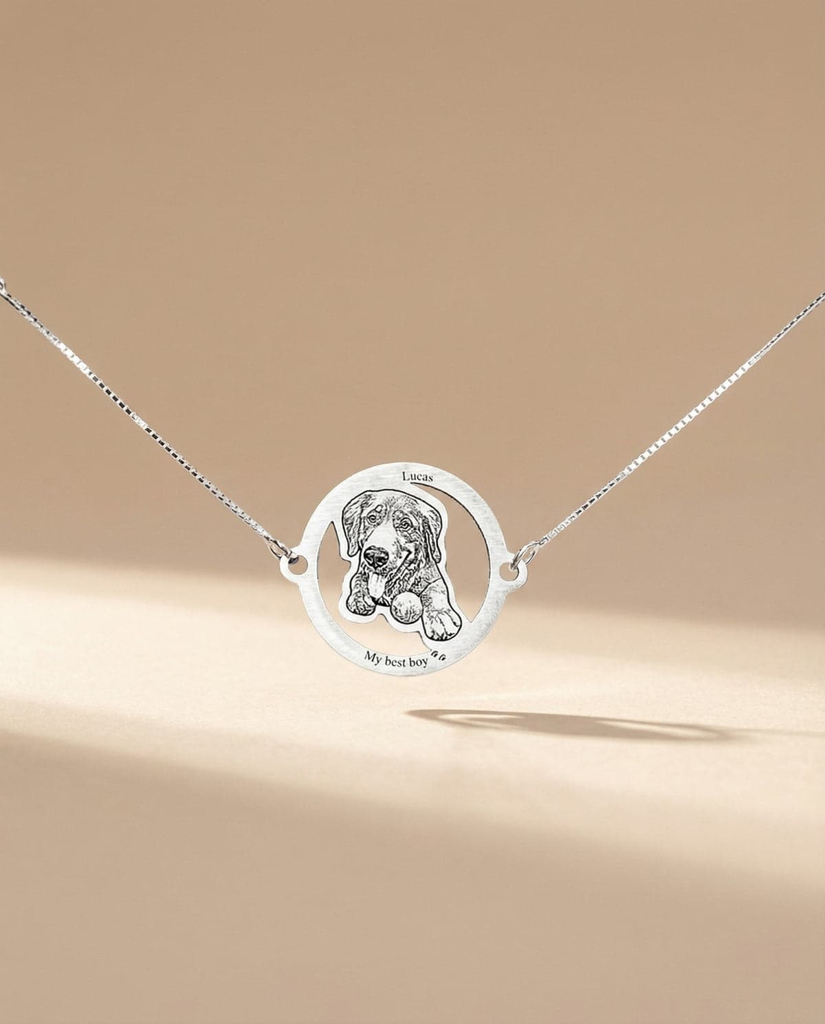 A silver round cut-out charm bracelet engraved "Lucas — My best boy" with a dog portrait.